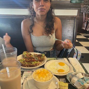 Metro Diner - Niece and her Avocado Toast, Cheesiest Grits and her 2 Eggs - Breakfast & Brunch Near Me - Jacksonville Beach, Florida