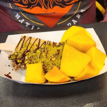 The Paleta Bar - Mango, pistachio, dark chocolate half dipped paleta. - Desserts Near Me - Albuquerque, New Mexico