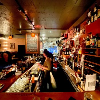 Ocho - a bar with people sitting at the bar - Tapas Bars Near Me - Seattle, Washington