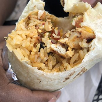 California Burritos - a hand holding a burrito - Mexican Near Me - Manchester, New Hampshire