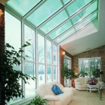 Four Seasons Sunrooms - a living room with large windows - Door Sales/Installation Near Me Four Seasons Sunrooms - a living room with large windows - Door Sales/Installation Near Me