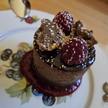 Jin Bar - Chocolate mousse truffle cake on a raspberry coulis with a hazelnut crunch topping - Bars Near Me - Calgary, Alberta