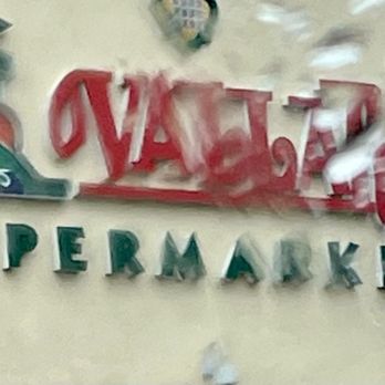 Vallarta Supermarkets - Vallarta logo through a rain-soaked window - Grocery Near Me - Fresno, California