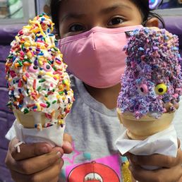 Soft serve with rainbow sprinkles and another with cotton candy sprinkles