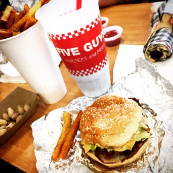 Five Guys - a hamburger and fries on a table - Burgers Near Me - Jupiter, Florida Five Guys - a hamburger and fries on a table - Burgers Near Me - Jupiter, Florida