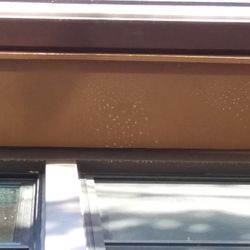 Cedar Tree Properties - White spots under eaves and along window frame.