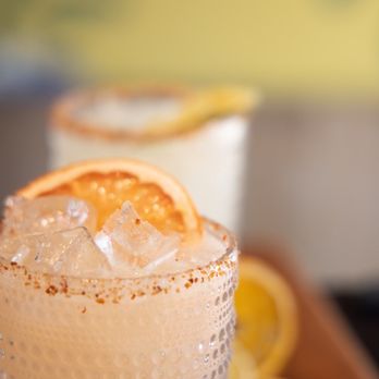 La Taqueria, Darien - a close up of a drink with a slice of orange - New Mexican Cuisine Near Me - Darien, Connecticut La Taqueria, Darien - a close up of a drink with a slice of orange - New Mexican Cuisine Near Me - Darien, Connecticut