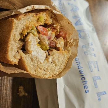 Sandwell - a sandwich in a paper bag on a wooden table - Sandwiches Near Me - New York, New York Sandwell - a sandwich in a paper bag on a wooden table - Sandwiches Near Me - New York, New York