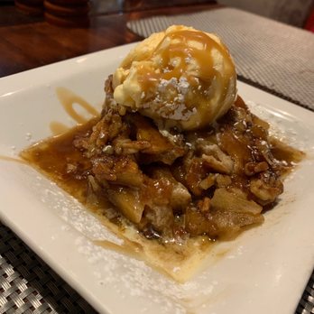 Cuts Steakhouse - Warm Apple cobbler with pecans and Carmel topped with ice cream. - Steakhouses Near Me - Atlanta, Georgia Cuts Steakhouse - Warm Apple cobbler with pecans and Carmel topped with ice cream. - Steakhouses Near Me - Atlanta, Georgia