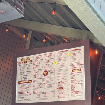 Phil's BBQ - Can view the menu hanging from the ceiling while waiting in line in the cool shaded patio breeze. - Barbeque Near Me - San Diego, California