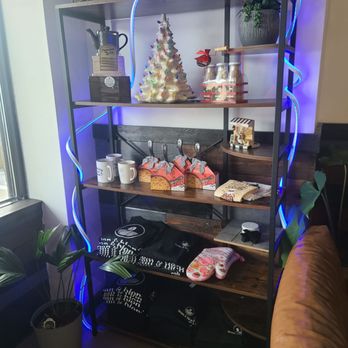 Bean and Blend Cafe - Display - A multi-tiered shelving unit displays Christmas decorations, mugs, and gift items, accented by blue LED strip lighting. - Coffee & Tea Near Me - Tabernacle, New Jersey