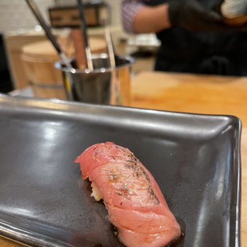5Kinokawa - a piece of salmon on a black plate - Japanese Near Me - Houston, Texas 5Kinokawa - a piece of salmon on a black plate - Japanese Near Me - Houston, Texas