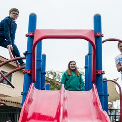 Three kids having fun playing on the playground