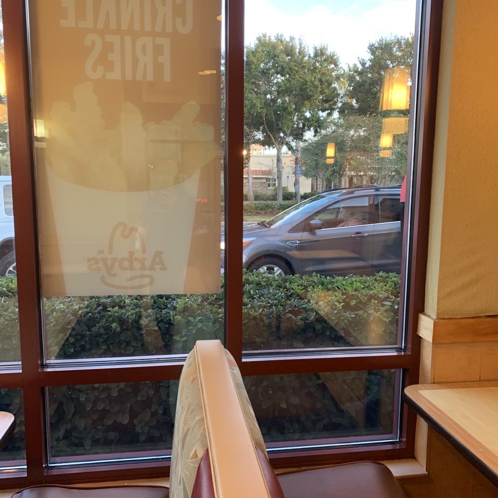 Arby's - Lovely view of cars and the back of advertisements - Fast Food Near Me - Lady Lake, Florida