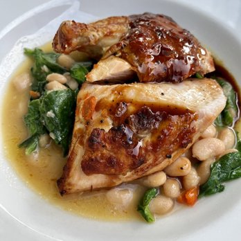 The Riverside Inn - Otto's Farm Chicken in white bean ragout with black truffle jus - New American Near Me - Leland, Michigan