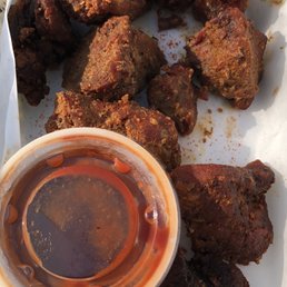 a plate of fried meat and a bowl of sauce a plate of fried meat and a bowl of sauce