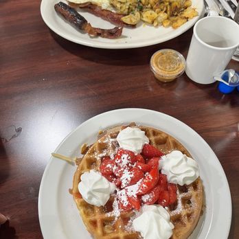 Rodeo Cafe - Combo plate with strawberrry waffle and up top right is bacon and eggs plate with potato's. - Breakfast & Brunch Near Me - Corona, California