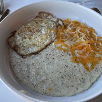 JDs - Breakfast Bowl with egg and cheese served over grits. Don't mind the pepper. I forgot to take the picture before adding! - Cafes Near Me - Waco, Texas