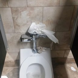 Crap in the toilet with a non-working sensor and crap on the toilet next door there's no way these bathrooms are checked every hour