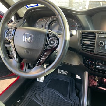 MHP Auto Services - The photo depicts the interior of a Honda car, focusing on the steering wheel, dashboard, and center console with climate controls. - Auto Detailing Near Me