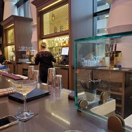 a bar with a glass of wine on the counter