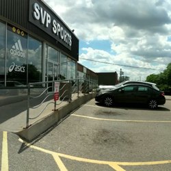 SVP Sports - Cartwright - Panoramic view of the front/side of the building from the east side of the parking lot & looking at the ramp up to the front door. July 2022