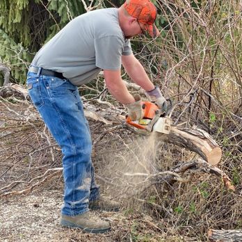 Bako's Custom Lawn Care - a man using a chainsaw - Lawn Services Near Me Bako's Custom Lawn Care - a man using a chainsaw - Lawn Services Near Me