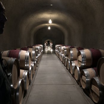 Quintessa Vineyard - Cave hallway with gorgeous barrels - Wineries Near Me - St. Helena, California Quintessa Vineyard - Cave hallway with gorgeous barrels - Wineries Near Me - St. Helena, California