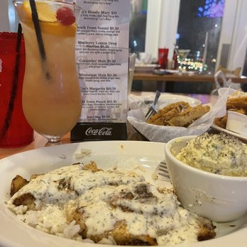 Cuz's - Stuffed catfish with seafood potato salad (potato's are boiled in seafood boil) with Beach Front Sunset Cocktail - Seafood Near Me - Bay Saint Louis, Mississippi