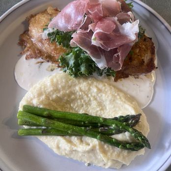 Severo - Anabelle Chicken - A dish with mashed potatoes topped with asparagus, a fried item with sauce, and prosciutto on greens, served on a white plate. - American Near Me - Richfield, Utah