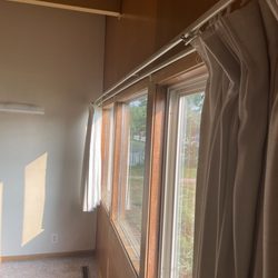 Real Estate 1 - Curtains in living room that need to be safety pinned closed as they are falling apart