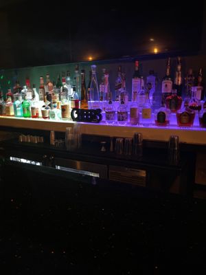 Photo of The District Sports Bar - Washington, DC, DC, US. a row of liquor bottles