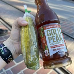 Mobile ordered drink to grab a pickle from a cart Mobile ordered drink to grab a pickle from a cart