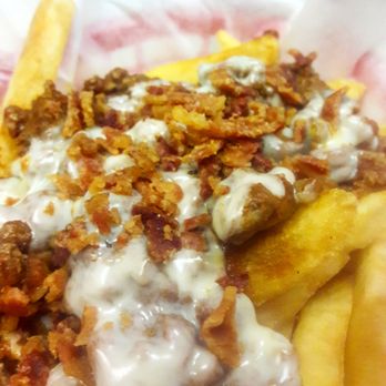 Grumpy's Tavern - a plate of french fries with cheese sauce - Dive Bars Near Me - Philadelphia, Pennsylvania