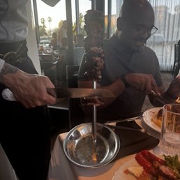 Fellow Elite Yelper eating one of the amazing meats. Fellow Elite Yelper eating one of the amazing meats.