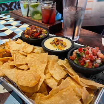Condado Tacos - THREE BUDS trio dip: PICO guacamole, ELOTE queso, PINEAPPLE salsa - Tacos Near Me - Troy, Michigan