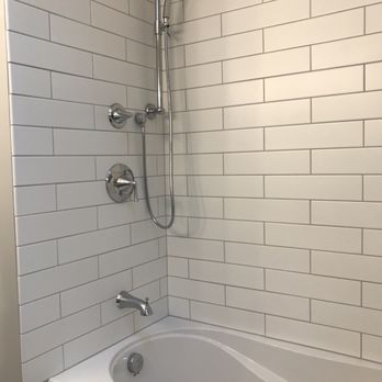 Stephanie's Renovations - Shower tile with new hardware, rain shower and separate hand held shower - Painters Near Me Stephanie's Renovations - Shower tile with new hardware, rain shower and separate hand held shower - Painters Near Me
