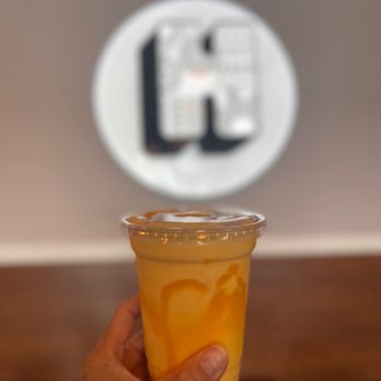 Hocco - The Indian Kitchen - a hand holding a cup of orange juice - Indian Near Me - Chesapeake, Virginia Hocco - The Indian Kitchen - a hand holding a cup of orange juice - Indian Near Me - Chesapeake, Virginia