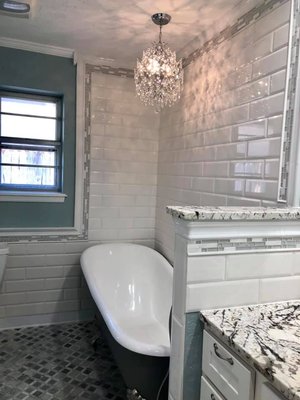 Bathroom Remodel - The enchanted Cinderella's bathroom got created dressing up the elegant
modern/ antique customized cast iron bath tub, beautiful natural marble floors, 6 diferent exclusive designer tile, new vanity and remodeled cabinets, 3cm brasilian granite countertop, antique sink with cast iron accent, Glass, porcelain, marble, cast iron, mirror wall, stainless steel hardware, exotic granite, and the touch of Hunter Home Improvement. Call us with your personal home project dreams!!