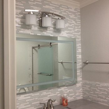 JMJ Construction - a bathroom with a sink and mirror - General Contractors Near Me JMJ Construction - a bathroom with a sink and mirror - General Contractors Near Me