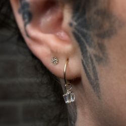 Wonderland Body Arts - Simple second lobe into a 14k gold disc. First hole is rocking a 14k gold hoop with a baguette cluster charm.