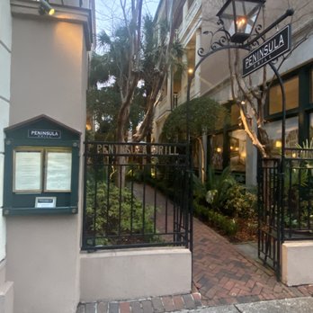 Peninsula Grill - Garden entry with posted menu - New American Near Me - Charleston, South Carolina