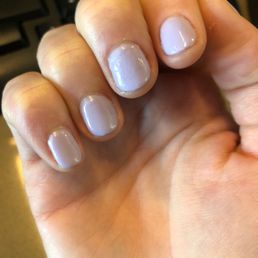 Bumpy uneven nails. Top coat is not shiny. Cuticles are messy.