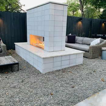 The Amsterdam - Outdoor fireplace and seating area in back - New American Near Me - Rhinebeck, New York