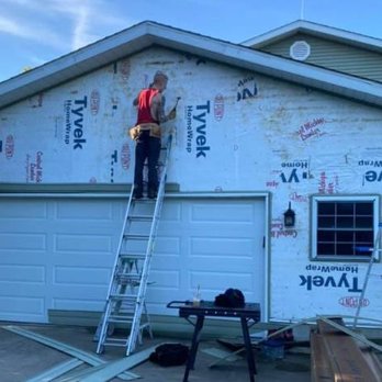 Feldmann Construction - a man on a ladder working on a house - General Contractors Near Me Feldmann Construction - a man on a ladder working on a house - General Contractors Near Me