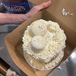 Chocolate cake with vanilla frosting, topped with macaroons