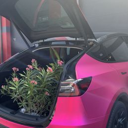 Model Y wrapped in Hexis Satin Pink Super Chrome Vinyl and Stek DYNOforged-carbon fiber accents.