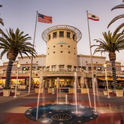 Pacific View - Pacific View entrance, fountains and palm trees illuminated at dusk.