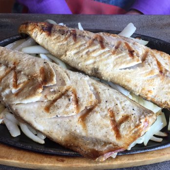 Sushi House - Saba shioyaki: salt-broiled mackerel on a sizzling platter at table. - Sushi Bars Near Me - Olympia, Washington Sushi House - Saba shioyaki: salt-broiled mackerel on a sizzling platter at table. - Sushi Bars Near Me - Olympia, Washington
