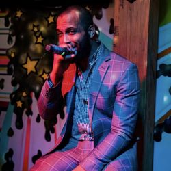 NoDa 101 - Singer on stage at karaoke bar